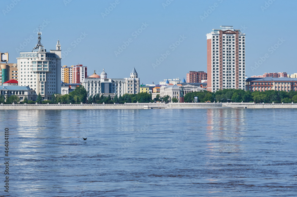 View of the embankment of the neighboring town of the neighboring country from the city of Blagoveshchensk, Russia. Flood period.