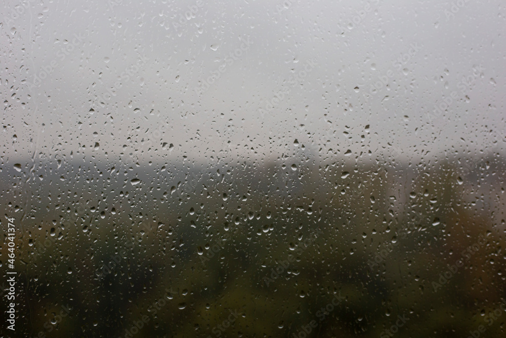 Window with raindrops and blurry view of the autumn forest Window with raindrops and blurry view of the autumn forest