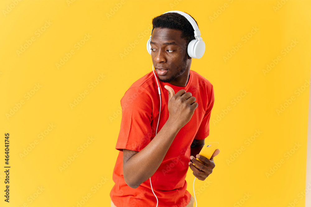 man of african appearance with a phone in his hands in headphones music entertainment man of african appearance with a phone in his hands in headphones music entertainment