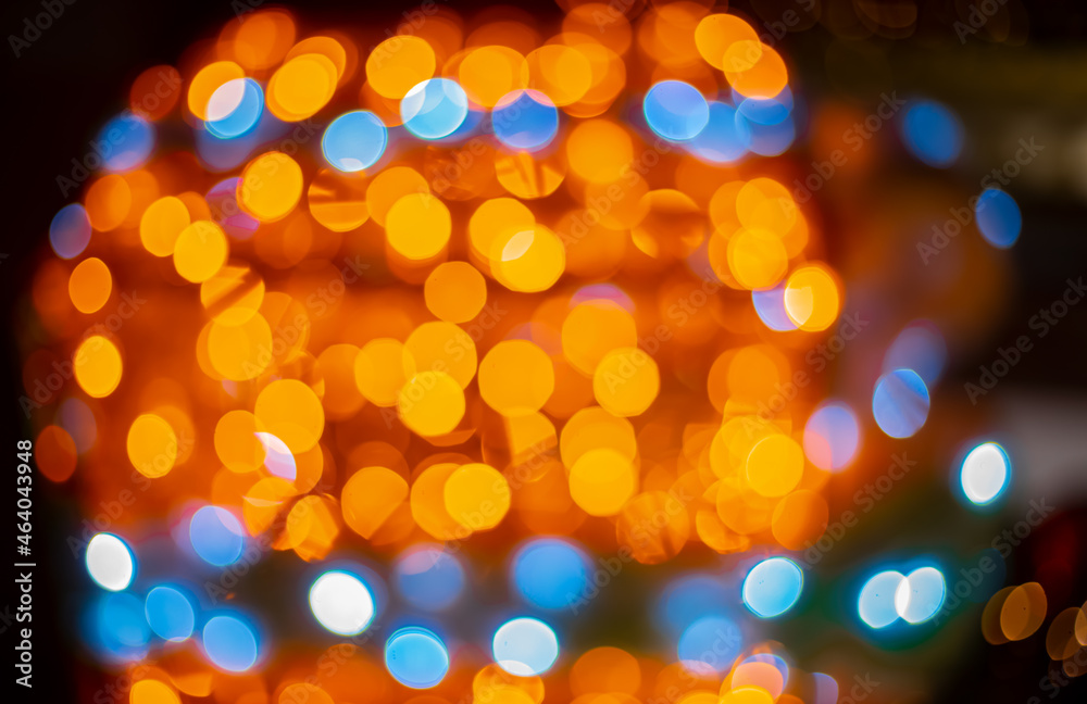 Obraz premium yellow and blue color lamps of garland festive bokeh effect lighting in Christmas festive time, unfocused background photography