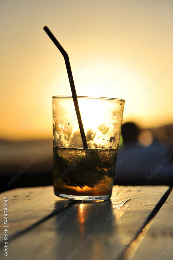 Mojito cocktail at sunset in a beach bar (chiringuito). Coast of Light in Cadiz Andalusia Spain Mojito cocktail at sunset in a beach bar (chiringuito). Coast of Light in Cadiz Andalusia Spain