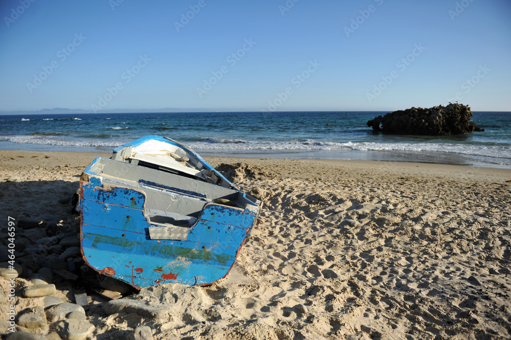 Samolepka Abandoned small wooden boat on a beach near Tarifa, coast of Andalusia, Spain