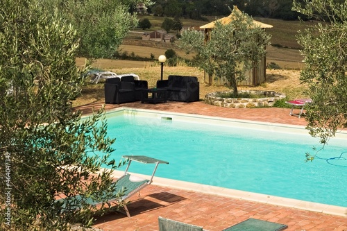 A pair of poolside sofas in the Italian countryside during a stormy day  Tuscany  Italy  Europe 