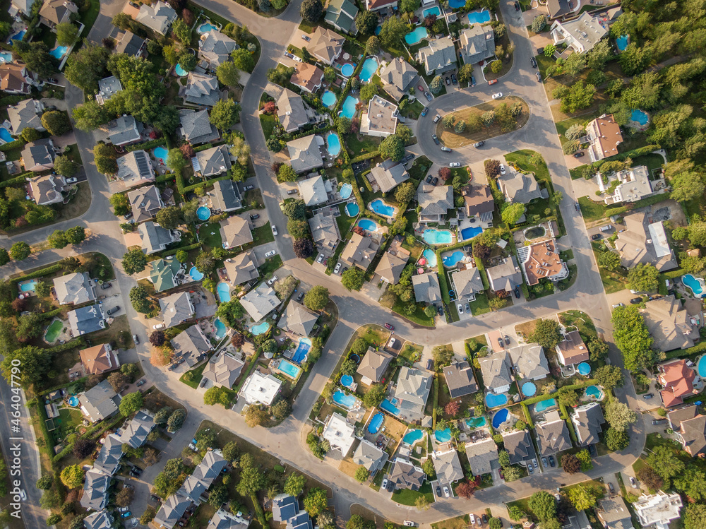 Top down aerial view of houses and streets in beautiful residential neighbourhood in Montreal, Quebec, Canada. Property, housing and real estate concept, summer season. Top down aerial view of houses and streets in beautiful residential neighbourhood in Montreal, Quebec, Canada. Property, housing and real estate concept, summer season.