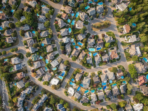 Top down aerial view of houses and streets in beautiful residential neighbourhood in Montreal, Quebec, Canada. Property, housing and real estate concept, summer season.
