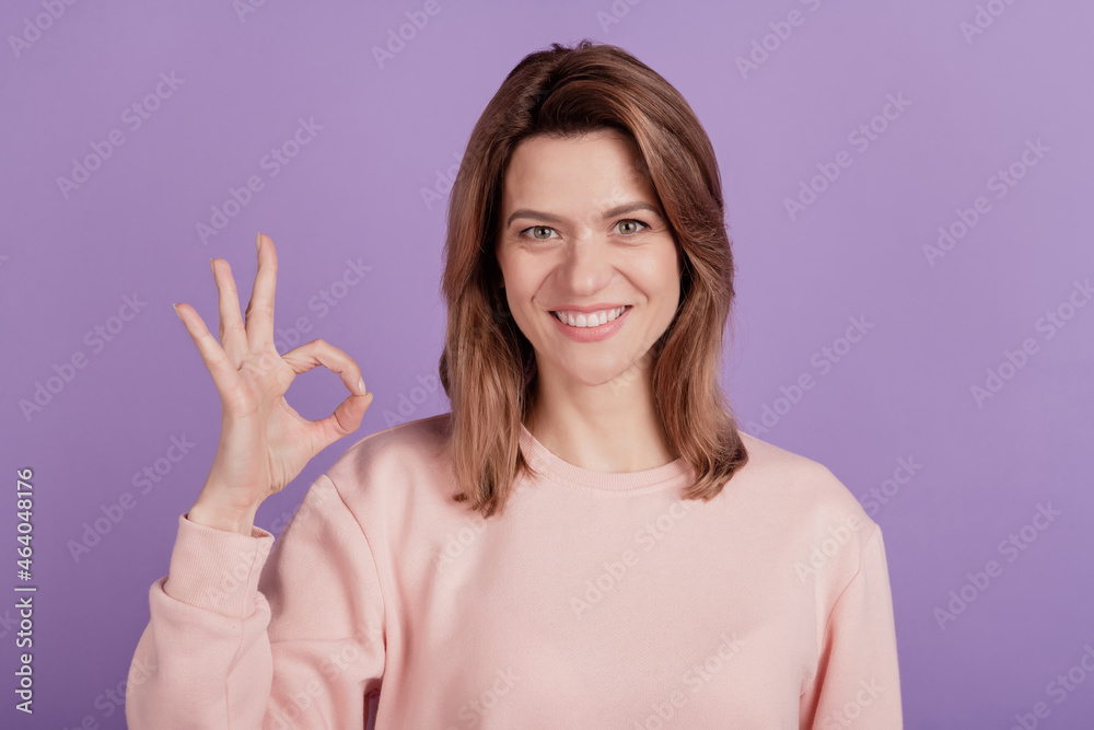 Photo of cute pretty lady demonstrate okey sign beaming smile wear casual shirt on violet background Photo of cute pretty lady demonstrate okey sign beaming smile wear casual shirt on violet background