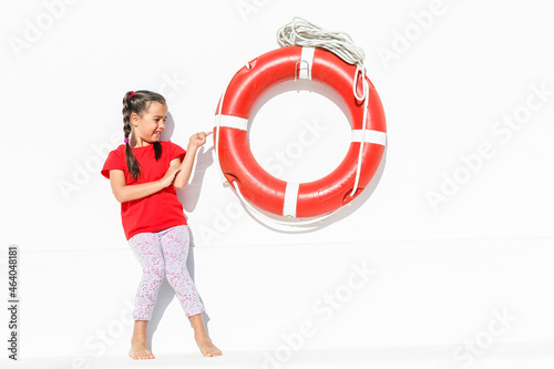 Portrait of little girl sea theme, little girl and lifebuoy