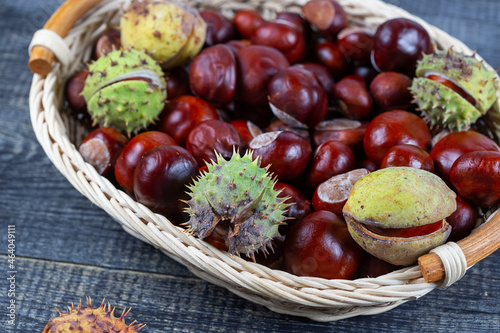 Chestnuts in a basket on a wooden background