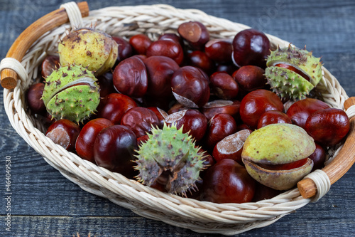 Chestnuts in a basket on a wooden background