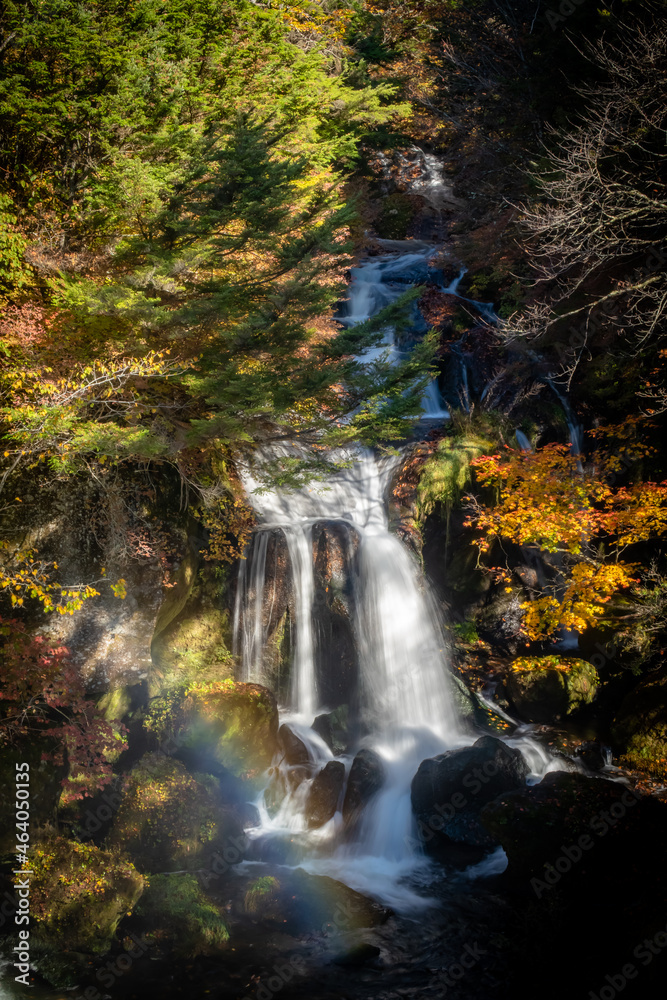 Ryuzu Falls with rainbow with colored leaves in autumn in Nikko, Tochigi, Japan. October 18, 2021. Ryuzu Falls with rainbow with colored leaves in autumn in Nikko, Tochigi, Japan. October 18, 2021.