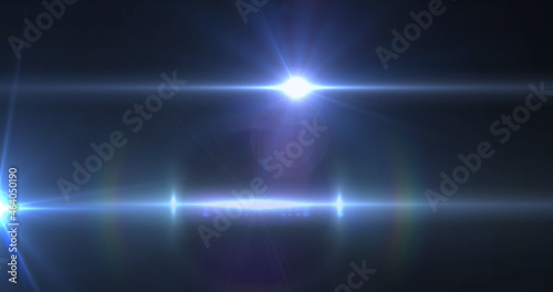 Image of light trails and spots over black background