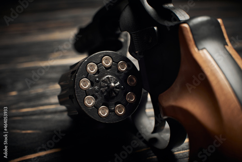 Photo revolver cylinder with Flobert ammo 4mm on dark wooden background