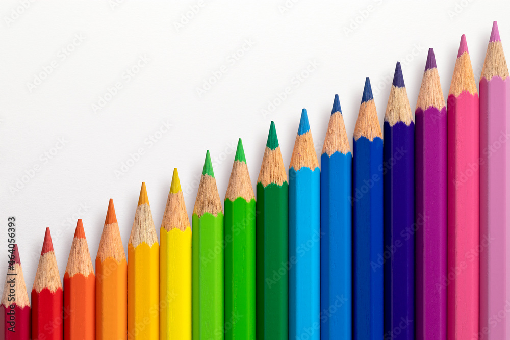 Colour pencils arranged diagonally on a white paper background. Colour pencils arranged diagonally on a white paper background.