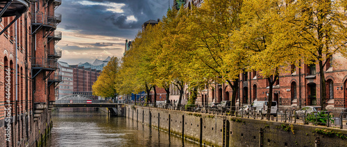 tree-lined canal and historic buildings in old warehouse district Speicherstadt in Hamburg, Germany photo