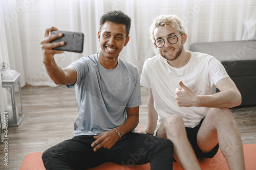 Two male friends taking selfie after home workout