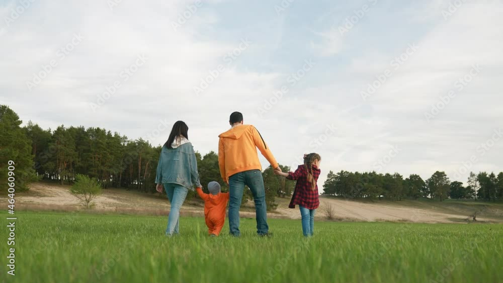 people in the park. happy family a walk at sunset. mom dad and daughter walk holding hands in the park. happy family kid dream concept. life parents and fun baby walking forest park people in the park. happy family a walk at sunset. mom dad and daughter walk holding hands in the park. happy family kid dream concept. life parents and fun baby walking forest park
