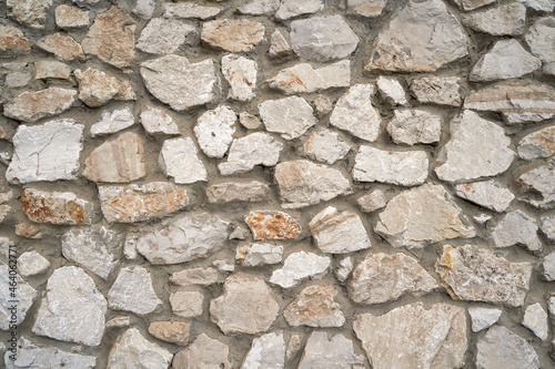 Old brick wall, old texture of red stone blocks closeup