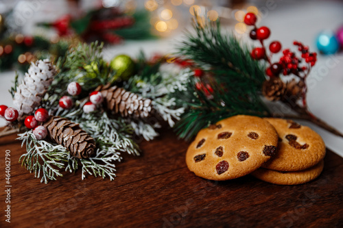 Festive Christmas and new year card with cookie on dark wooden background