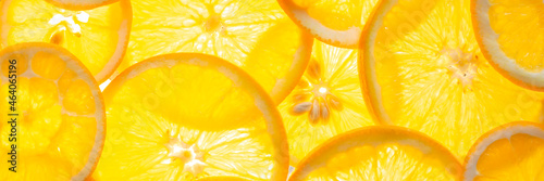 Fresh orange slices on a glowing surface Banner