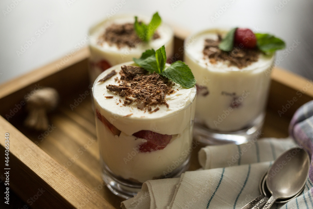 Dessert in a transparent glass on a wooden tray Dessert in a transparent glass on a wooden tray