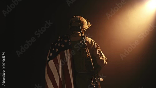 Veterans Day, Honoring all who served. Soldier in front of American Flag. Soldier with automatic rifle.