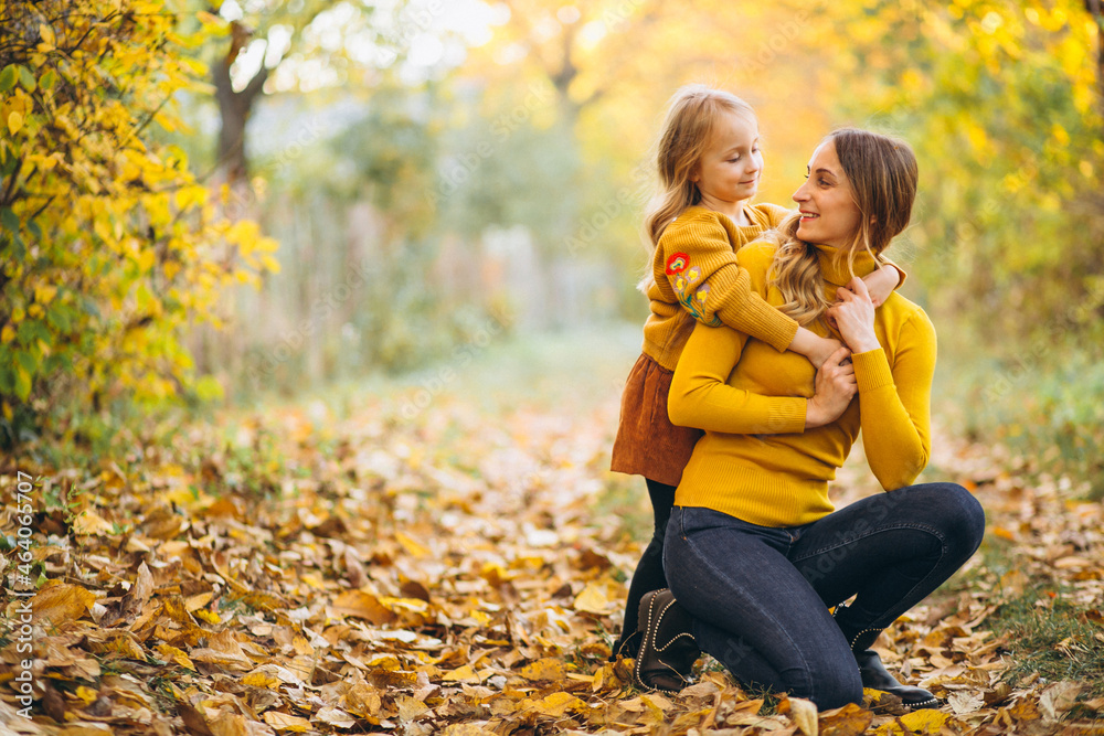 Mother and daughter in park full of leaves Mother and daughter in park full of leaves