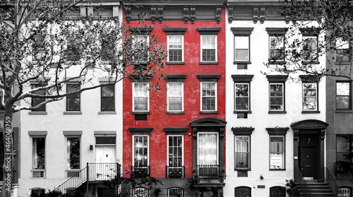 Photography Red brick building isolated against row of old black and white buildings in Manh