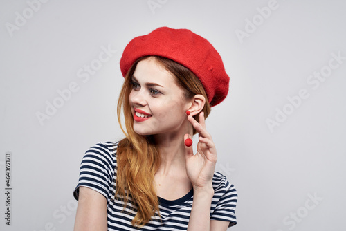 cheerful woman wearing a red hat makeup France Europe fashion posing light background