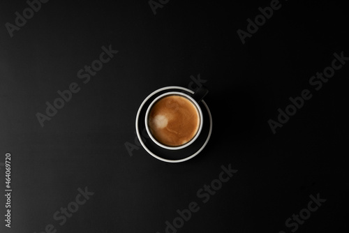 Cup of coffee on black background. Modern Lifestyle Flat-lay Top-down Minimalist Flat-lay. Top view. Copy space. photo