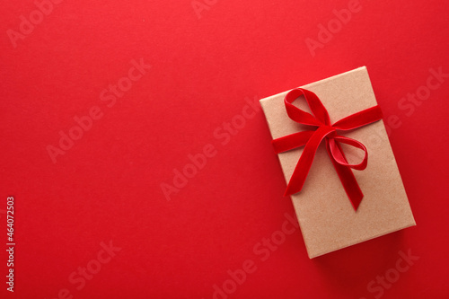 Christmas presents box. New Year or Christmas flat lay top view Xmas holiday celebration decoration red paper background with copyspace. Template mockup greeting card text design