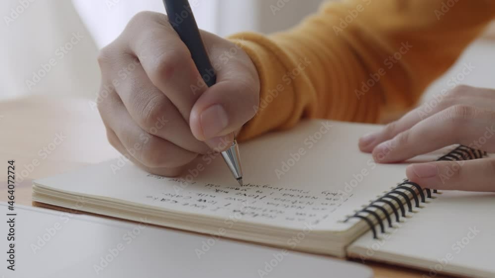 Hand of young women doing homework and  learning online at home