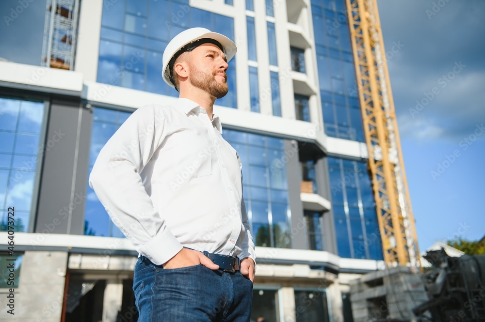 Architect in helmet near new building Architect in helmet near new building