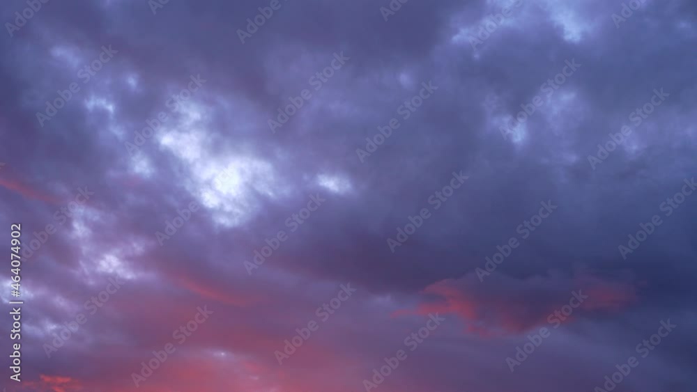 Beautiful evening blue sky at sunset with flaming bright light clouds. A warm summer evening at sunset. Bright sunset. Beautiful evening blue sky at sunset with flaming bright light clouds. A warm summer evening at sunset. Bright sunset.