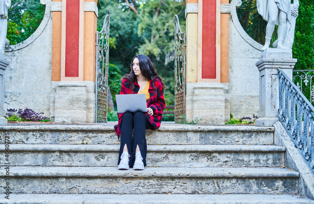 college student girl studying with laptop in the park