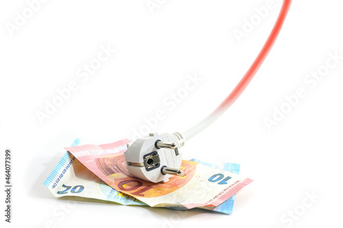 Electric schuko plug lying on euro banknotes, the cable is rising and turns to red, symbol of increasing energy costs, isolated on a white background, copy space