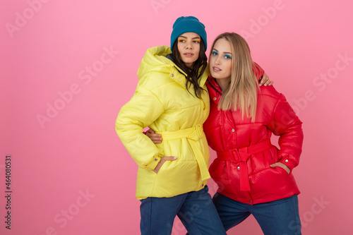 pretty women friends in colorful down jacket
