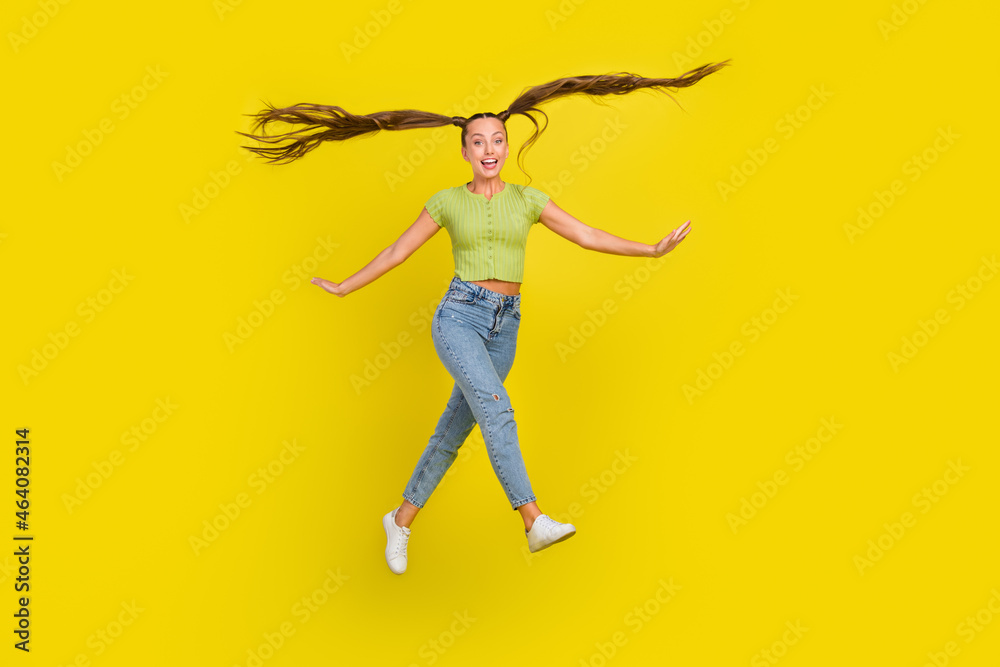 Full length body size view of attractive cheerful girl jumping good mood fooling isolated over bright yellow color background
