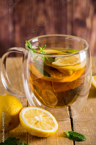 Tea with lemon and mint in transparent cup. Alternative medicine. Hot drink for relaxation.