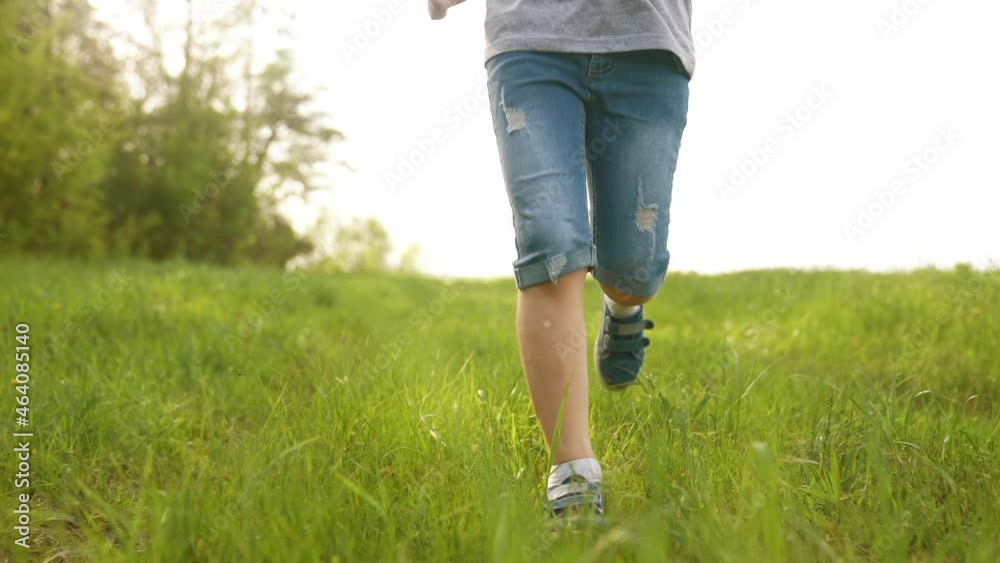 happy family. kid run legs close-up in the park at sunset. people in the park lifestyle concept boy son joyful run. happy family summer. little baby run child fun summer kid dream concept happy family. kid run legs close-up in the park at sunset. people in the park lifestyle concept boy son joyful run. happy family summer. little baby run child fun summer kid dream concept