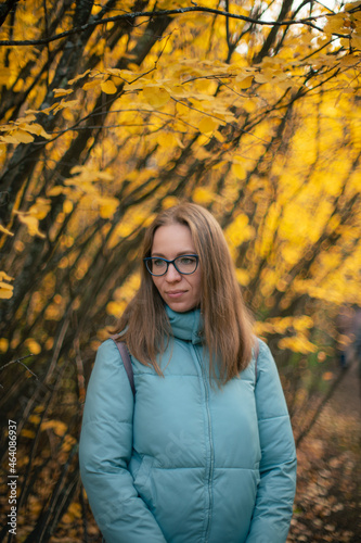 Autumn portrait of beautiful woman on fall nature background © olinchuk