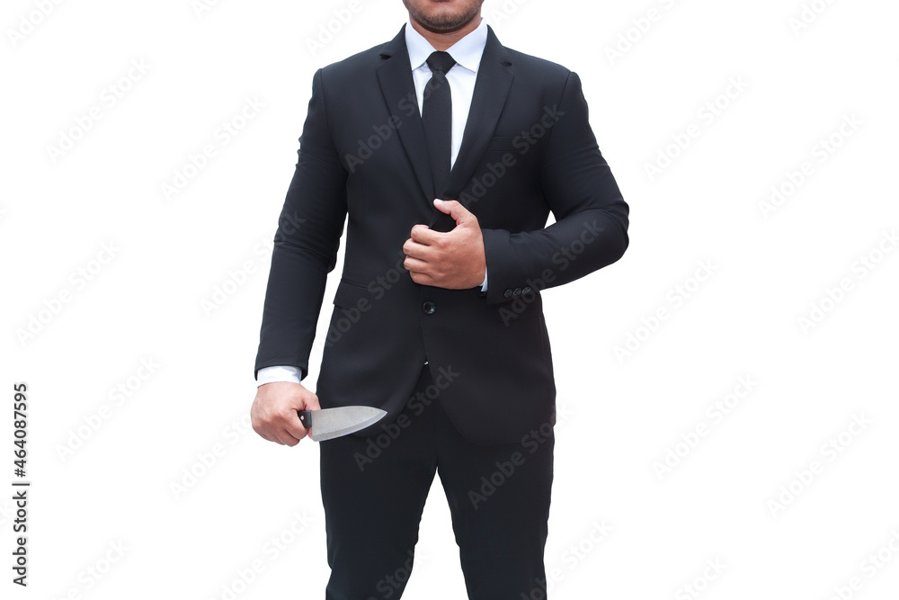 A businessman wearing a black suit stands with a knife on a white background isolated.businessman murder. A businessman wearing a black suit stands with a knife on a white background isolated.businessman murder.