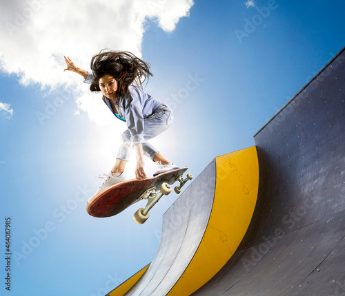 Skateboarder doing a jumping trick photo