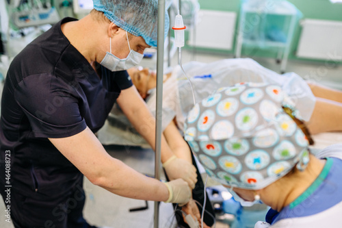 Male doctor injecting Epidural Anesthesia for pregnancy Labor during childbirth for woman pathient in hospital. Prepare for surgery. Medical background