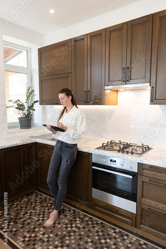 Woman working in her kitchen from home in a modern scandinavian kitchen