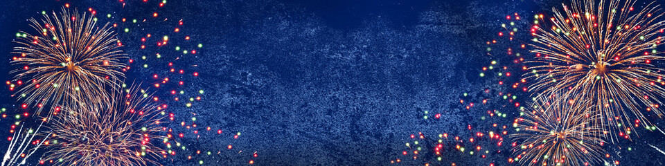 Silvester, new year background - fireworks on rustic dark blue stone concrete texture, top view with space for text