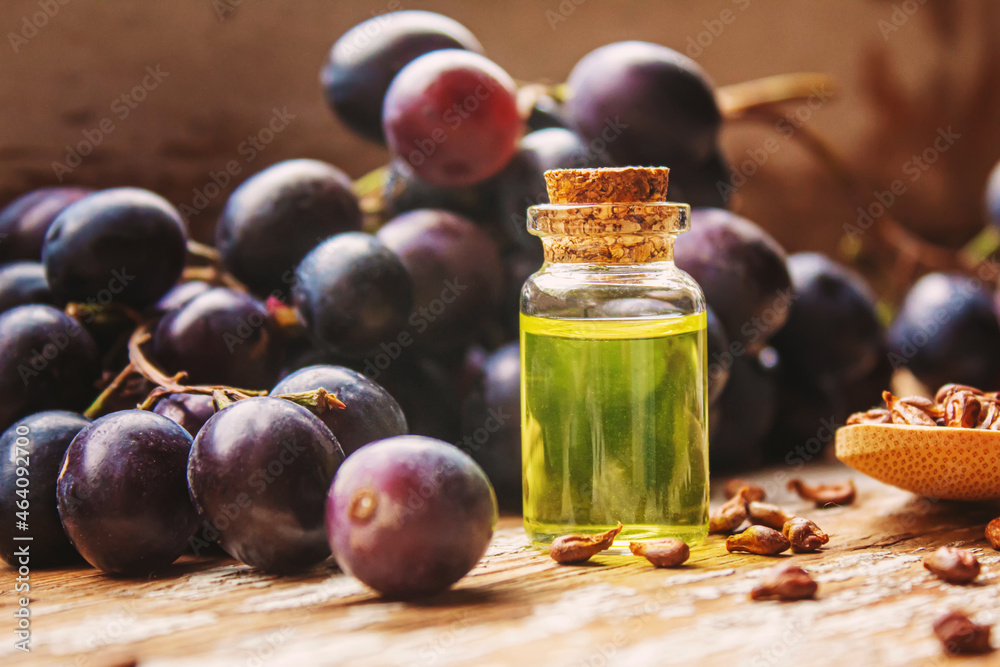 Extract of grape oil in a small jar. Selective focus. food Extract of grape oil in a small jar. Selective focus. food