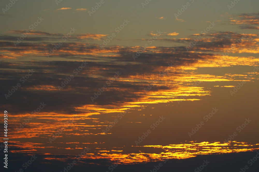  Evening sky with bright, golden and dark clouds.