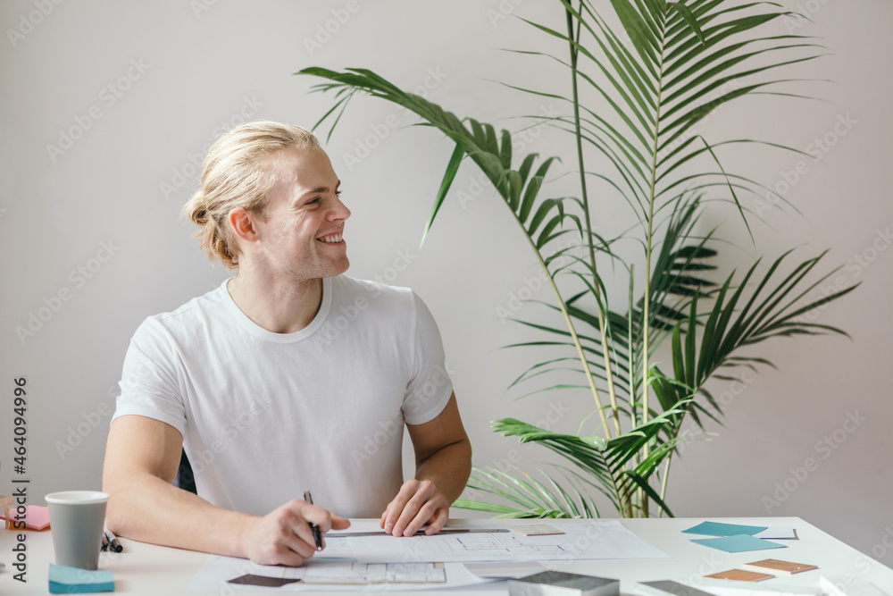 © Austockphoto - Guy at work looking off camera across the office studio