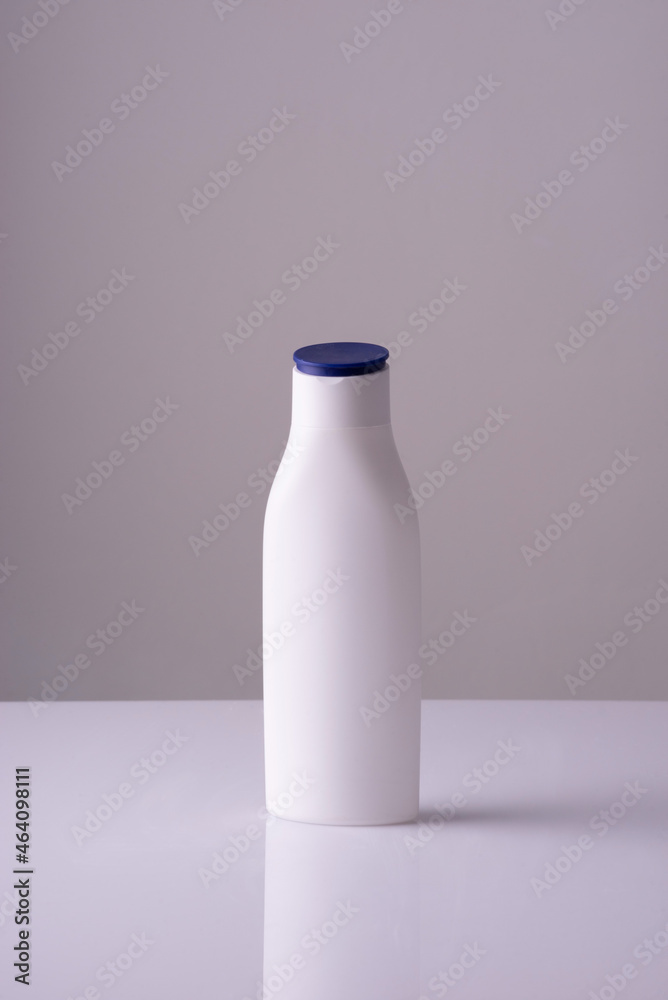 white bottle of cream on a white-gray background background. Skin care cream, anti-tan white bottle of cream on a white-gray background background. Skin care cream, anti-tan