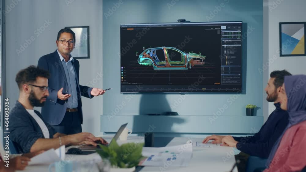 Multi-Ethnic Office Conference Room Meeting: Indian Industrial Engineer Presents Car Concept to a team of Technicians Talk, Use TV with 3D Vehicle Prototype Concept. Eco-friendly, Green Energy Multi-Ethnic Office Conference Room Meeting: Indian Industrial Engineer Presents Car Concept to a team of Technicians Talk, Use TV with 3D Vehicle Prototype Concept. Eco-friendly, Green Energy